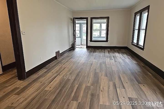 121 Altgeld St, South Bend, IN 46614 - spare room with ornamental molding, dark wood-type flooring, and baseboards