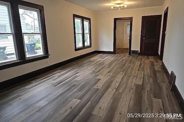 121 Altgeld St, South Bend, IN 46614 - empty room featuring dark wood-style flooring, ornamental molding, and baseboards