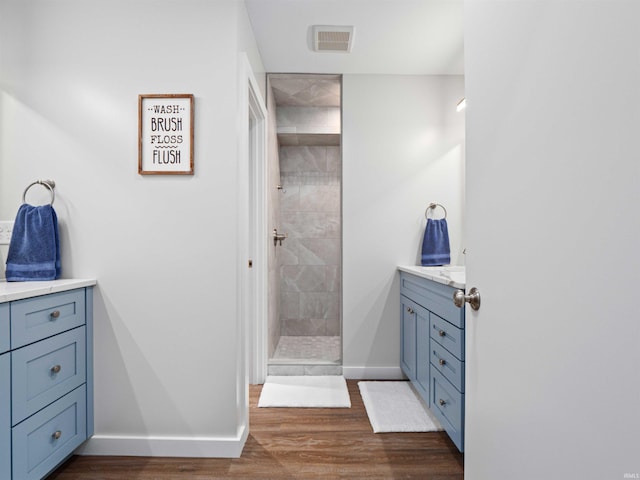 10660 N Southshore Dr Unit D3, Syracuse, IN 46567 - bathroom with vanity, tiled shower, wood finished floors, and baseboards