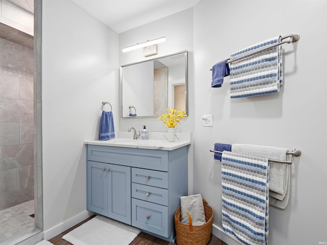 10660 N Southshore Dr Unit D3, Syracuse, IN 46567 - full bathroom featuring vanity, tiled shower, wood finished floors, and baseboards