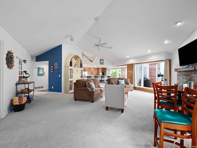 10660 N Southshore Dr Unit D3, Syracuse, IN 46567 - carpeted living room featuring vaulted ceiling, a ceiling fan, a stone fireplace, recessed lighting, and baseboards