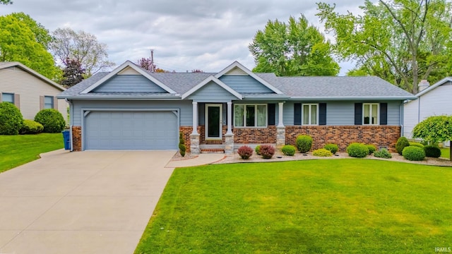 1023 Sunset Dr, Wabash, IN 46992 - view of front facade with an attached garage, brick siding, a front yard, and concrete driveway