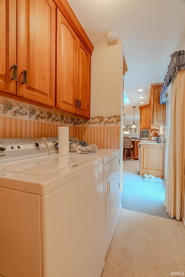1023 Sunset Dr, Wabash, IN 46992 - washroom featuring washer and dryer, light carpet, cabinet space, and wallpapered walls