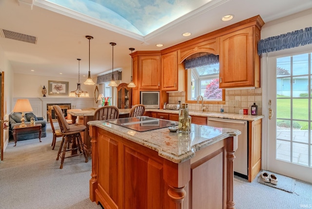 1023 Sunset Dr, Wabash, IN 46992 - kitchen featuring stainless steel dishwasher, black electric cooktop, light carpet, a kitchen island, and a sink