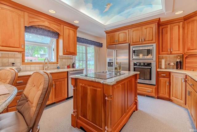 1023 Sunset Dr, Wabash, IN 46992 - kitchen featuring appliances with stainless steel finishes, light carpet, tasteful backsplash, light stone countertops, and a center island