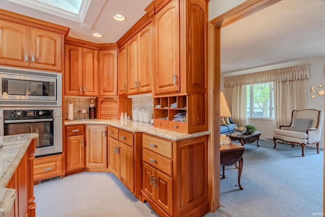 1023 Sunset Dr, Wabash, IN 46992 - kitchen with appliances with stainless steel finishes, light colored carpet, light stone countertops, recessed lighting, and brown cabinets