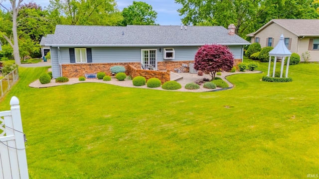 1023 Sunset Dr, Wabash, IN 46992 - view of front of house featuring brick siding, a chimney, and roof with shingles