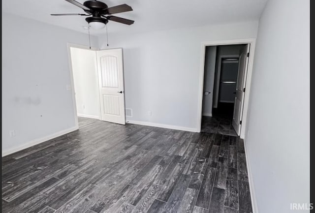 3981 Gussie Ct, Warsaw, IN 46582 - spare room featuring dark wood-style floors, a ceiling fan, and baseboards