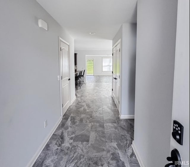 3981 Gussie Ct, Warsaw, IN 46582 - hall featuring baseboards and dark marble finish flooring