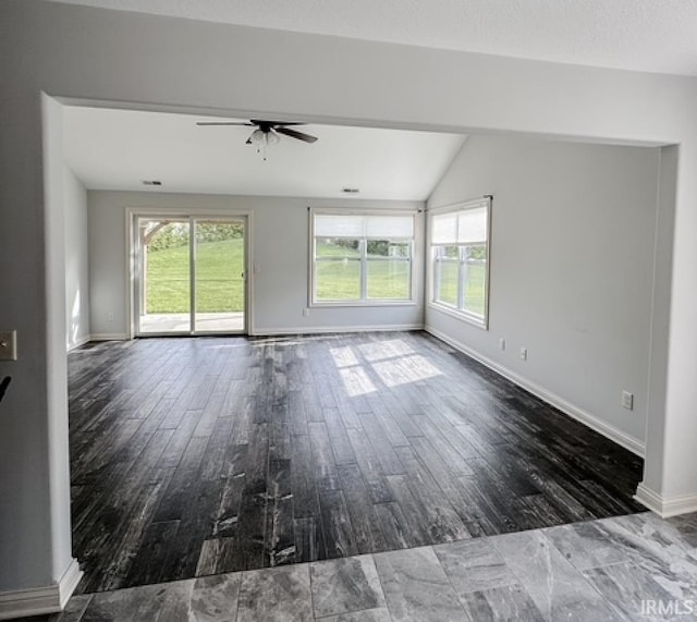 3981 Gussie Ct, Warsaw, IN 46582 - unfurnished living room featuring healthy amount of natural light, ceiling fan, wood finished floors, vaulted ceiling, and baseboards