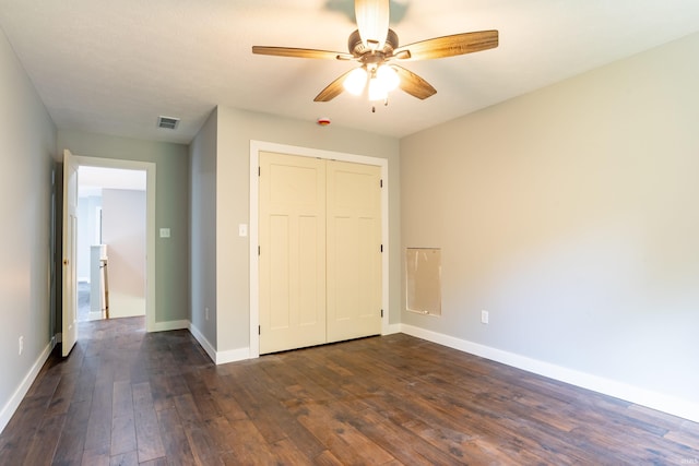 2075 N Russell Rd, Bloomington, IN 47408 - unfurnished bedroom featuring dark wood-style flooring, baseboards, a closet, and a ceiling fan