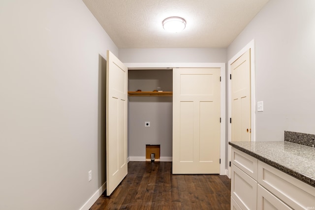 2075 N Russell Rd, Bloomington, IN 47408 - laundry area with electric dryer hookup, dark wood finished floors, a textured ceiling, and baseboards