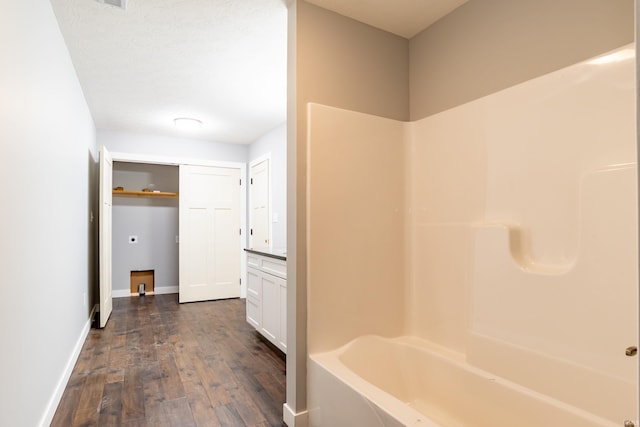 2075 N Russell Rd, Bloomington, IN 47408 - bathroom featuring wood finished floors, baseboards, and bathing tub / shower combination