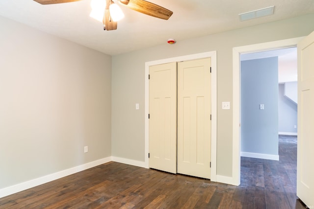 2075 N Russell Rd, Bloomington, IN 47408 - unfurnished bedroom featuring dark wood-style flooring, baseboards, a closet, and ceiling fan