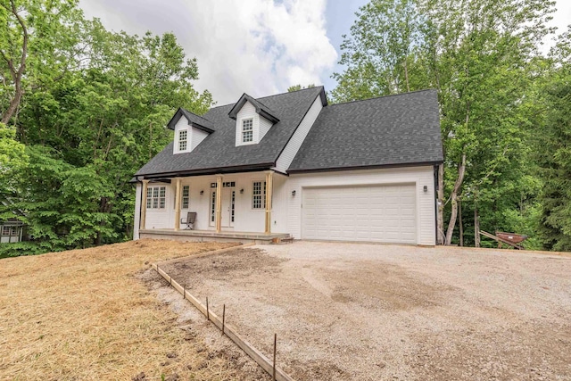 2075 N Russell Rd, Bloomington, IN 47408 - cape cod home featuring covered porch, an attached garage, dirt driveway, and a shingled roof