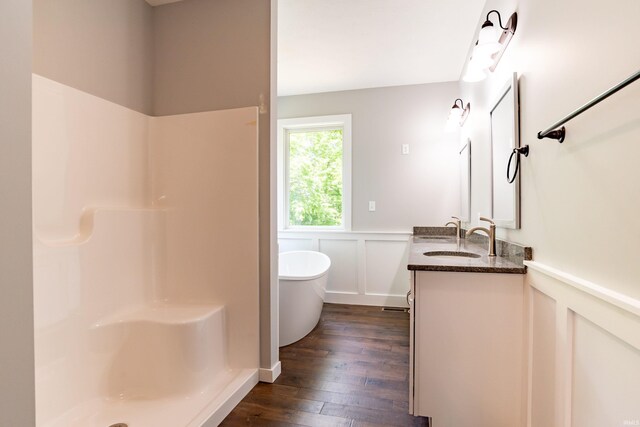 2075 N Russell Rd, Bloomington, IN 47408 - full bath with a wainscoted wall, double vanity, wood-type flooring, a decorative wall, and a freestanding bath