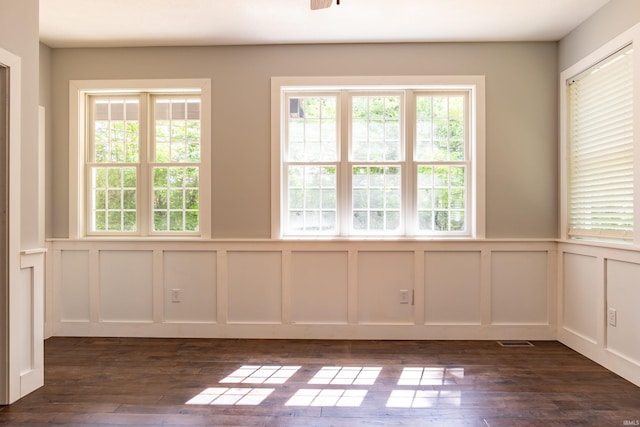 2075 N Russell Rd, Bloomington, IN 47408 - empty room with a decorative wall, plenty of natural light, dark wood-type flooring, and wainscoting