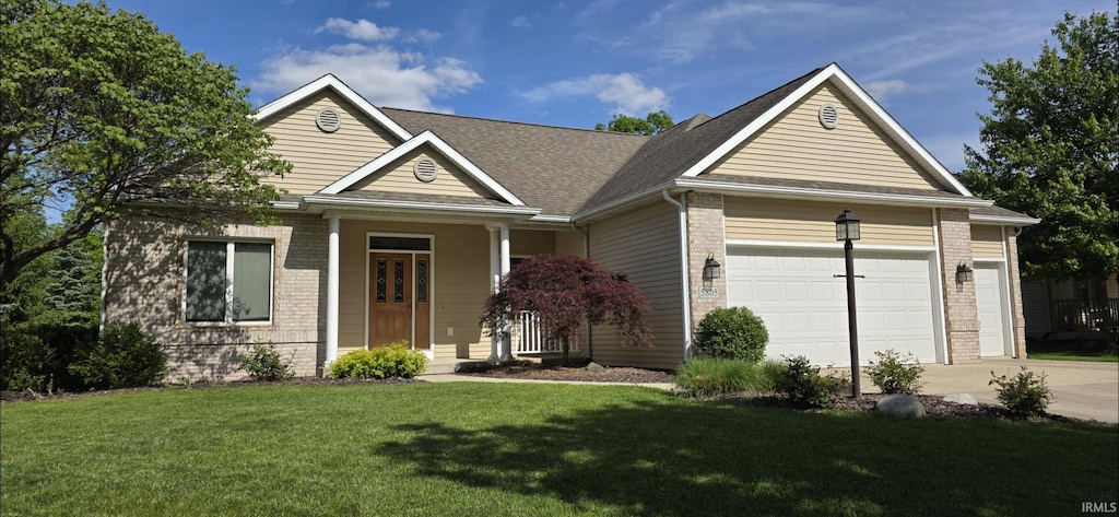 5805 Hemingway Run, Fort Wayne, IN 46814 - view of front of home featuring brick siding, driveway, a front lawn, and a garage