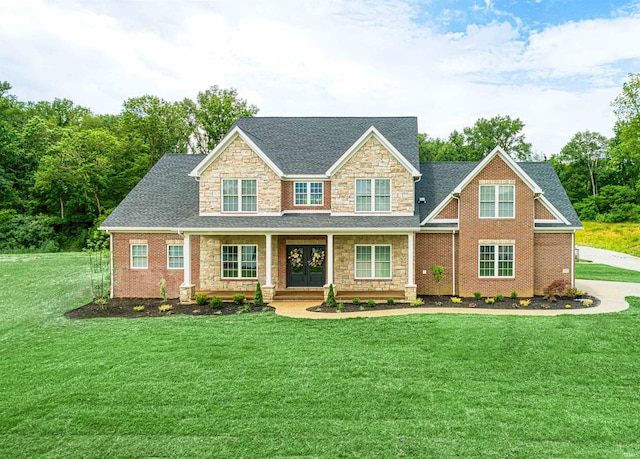 1595 Victoria Woods Dr, Boonville, IN 47601 - craftsman-style home featuring stone siding, a front lawn, covered porch, and roof with shingles
