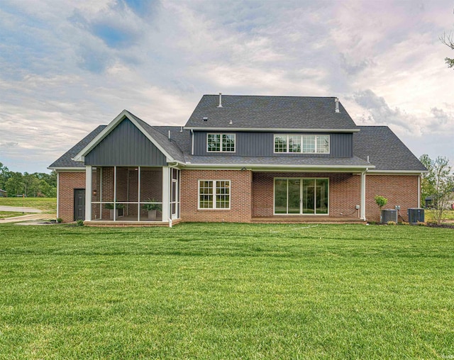 1595 Victoria Woods Dr, Boonville, IN 47601 - rear view of house featuring central AC, a lawn, a sunroom, and brick siding