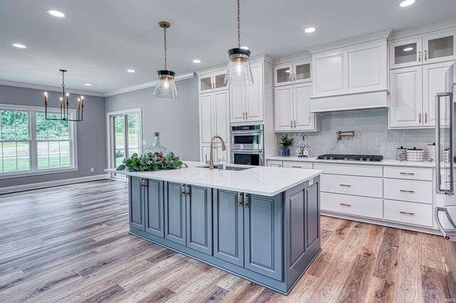 1595 Victoria Woods Dr, Boonville, IN 47601 - kitchen with a sink, light wood finished floors, white cabinets, double oven, and gas stovetop