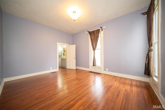819 Spring St, New Castle, IN 47362 - unfurnished room with wood finished floors and baseboards