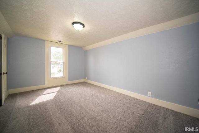 819 Spring St, New Castle, IN 47362 - additional living space featuring a textured ceiling, carpet flooring, baseboards, and vaulted ceiling