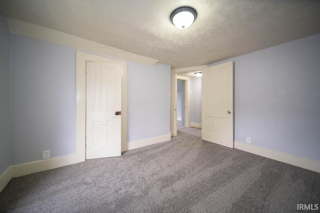 819 Spring St, New Castle, IN 47362 - unfurnished bedroom featuring a textured ceiling, carpet, and baseboards