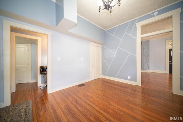 819 Spring St, New Castle, IN 47362 - unfurnished room featuring wood finished floors, baseboards, and a chandelier