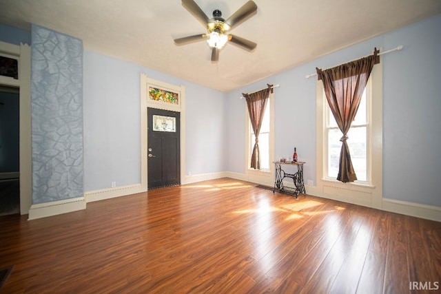 819 Spring St, New Castle, IN 47362 - unfurnished living room with ceiling fan, wood finished floors, and baseboards