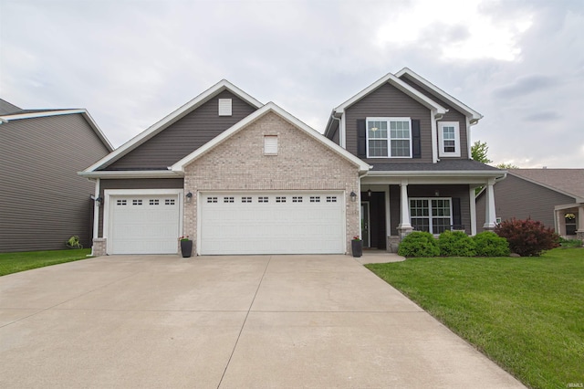 2184 Ringneck Rd, West Lafayette, IN 47906 - craftsman-style home featuring concrete driveway, a garage, a front yard, a porch, and brick siding