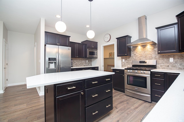 2184 Ringneck Rd, West Lafayette, IN 47906 - kitchen with appliances with stainless steel finishes, wall chimney exhaust hood, light countertops, light wood-style floors, and recessed lighting