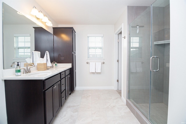 2184 Ringneck Rd, West Lafayette, IN 47906 - full bathroom with double vanity, a shower stall, marble finish flooring, and baseboards