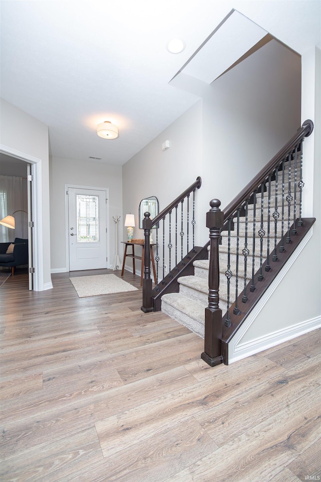 2184 Ringneck Rd, West Lafayette, IN 47906 - foyer entrance with wood finished floors, baseboards, and stairway