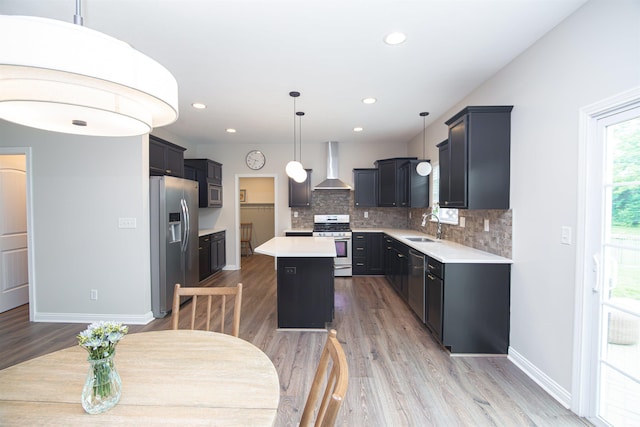 2184 Ringneck Rd, West Lafayette, IN 47906 - kitchen with appliances with stainless steel finishes, wall chimney range hood, a sink, a center island, and light countertops