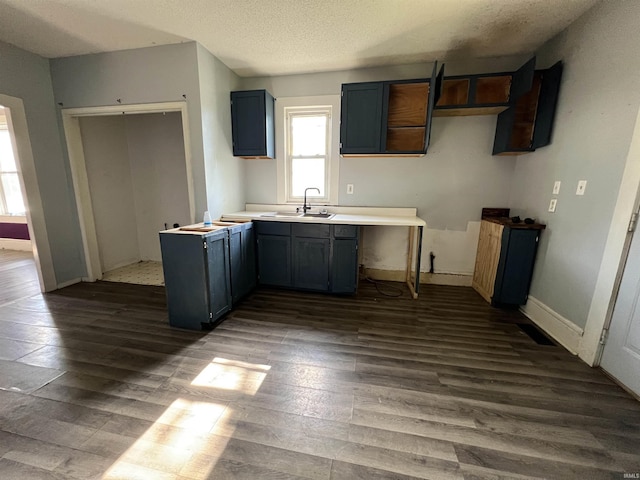 216 W Walnut St, Boonville, IN 47601 - kitchen featuring dark wood-type flooring, a sink, and baseboards