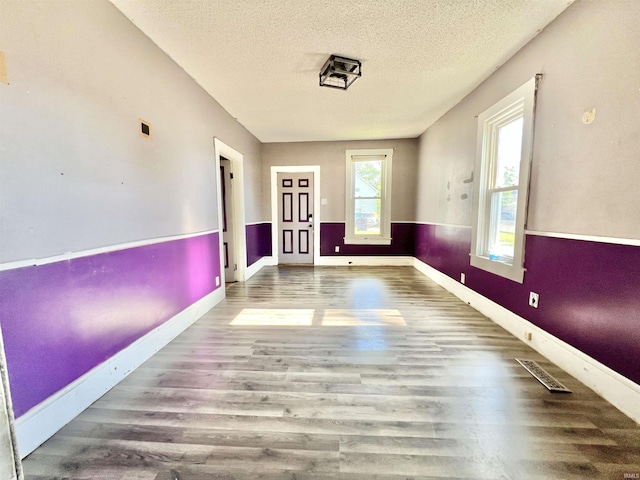 216 W Walnut St, Boonville, IN 47601 - empty room with wood finished floors, a textured ceiling, and baseboards