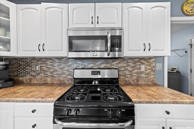 2034 Windflower Pl, West Lafayette, IN 47906 - kitchen with stainless steel microwave, range with gas stovetop, glass insert cabinets, backsplash, and white cabinets