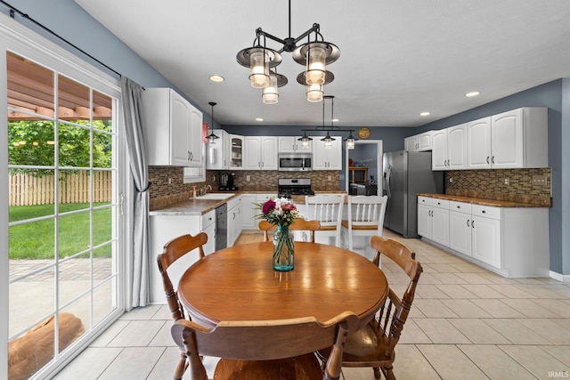 2034 Windflower Pl, West Lafayette, IN 47906 - dining area with light tile patterned floors, a chandelier, and recessed lighting