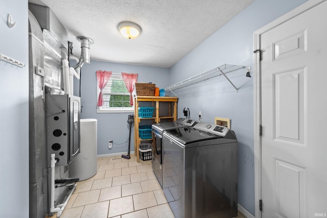 2034 Windflower Pl, West Lafayette, IN 47906 - washroom with washing machine and dryer, a textured ceiling, baseboards, and light tile patterned floors