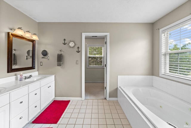 2034 Windflower Pl, West Lafayette, IN 47906 - bathroom with double vanity, a tub with jets, baseboards, and tile patterned flooring