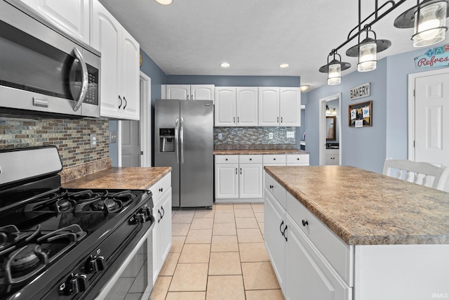2034 Windflower Pl, West Lafayette, IN 47906 - kitchen featuring stainless steel appliances, backsplash, white cabinetry, a kitchen island, and recessed lighting