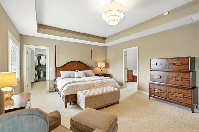 101 Twin Eagles Blvd W, Huntertown, IN 46748 - bedroom with light carpet, a tray ceiling, and a walk in closet