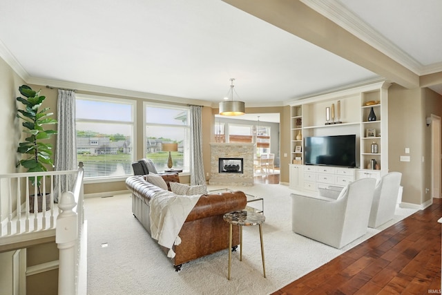 101 Twin Eagles Blvd W, Huntertown, IN 46748 - living room featuring ornamental molding, plenty of natural light, wood finished floors, baseboards, and a glass covered fireplace