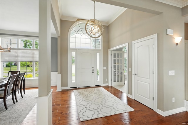 101 Twin Eagles Blvd W, Huntertown, IN 46748 - entryway with a chandelier, wood-type flooring, crown molding, baseboards, and a towering ceiling