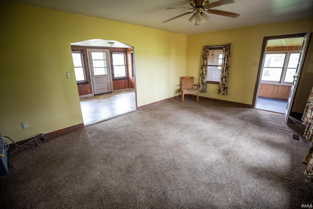 8147 15th Rd, Argos, IN 46501 - carpeted empty room featuring arched walkways, ceiling fan, plenty of natural light, and baseboards