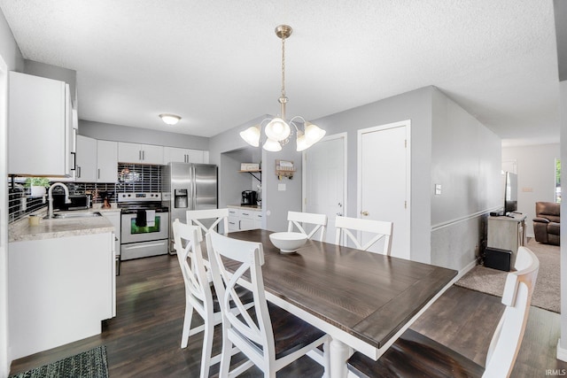 4618 Kekionga Dr, Fort Wayne, IN 46809 - dining space with dark wood-type flooring, a chandelier, a textured ceiling, and baseboards