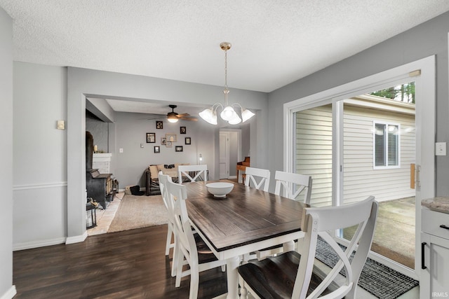 4618 Kekionga Dr, Fort Wayne, IN 46809 - dining room with dark wood finished floors, a fireplace, baseboards, a textured ceiling, and a chandelier