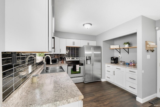 4618 Kekionga Dr, Fort Wayne, IN 46809 - kitchen with appliances with stainless steel finishes, a sink, tasteful backsplash, light countertops, and white cabinetry