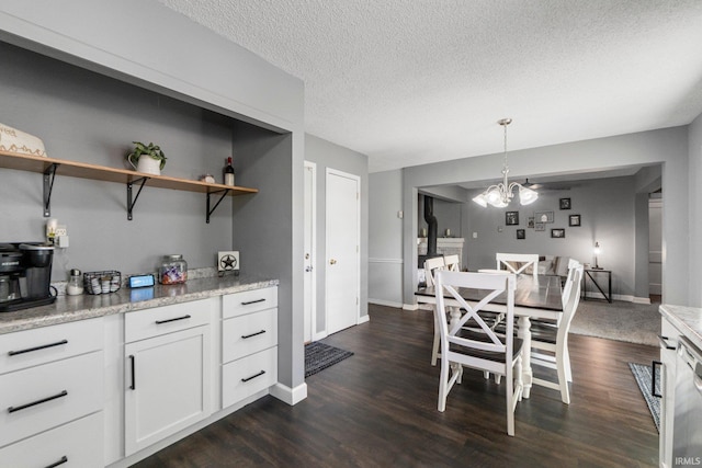 4618 Kekionga Dr, Fort Wayne, IN 46809 - dining room with a textured ceiling, baseboards, dark wood-type flooring, and a chandelier